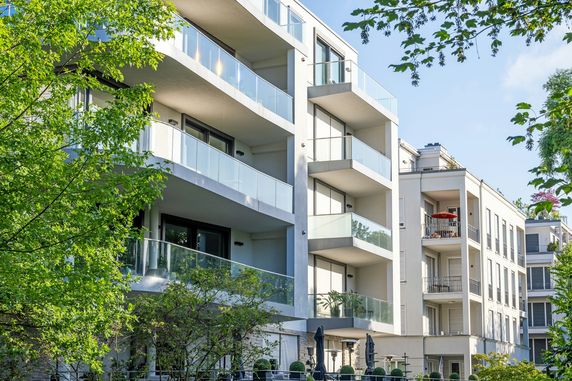 Modern apartment buildings surrounded by greens